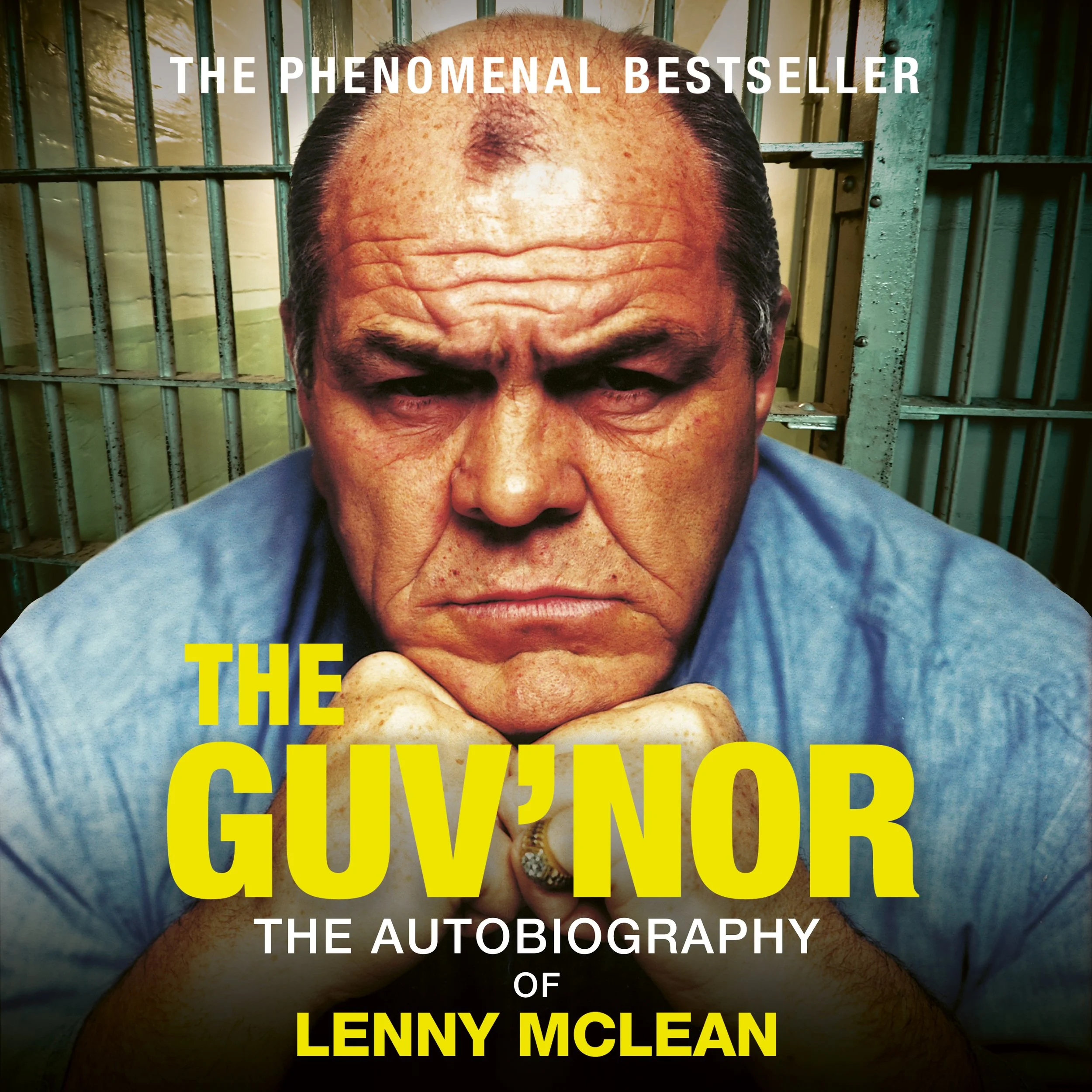 Cover of autobiography titled "The Phenomenal Bestseller" by Lenny McLean featuring a close-up of a man with a shaved head and facial scars, behind prison bars.