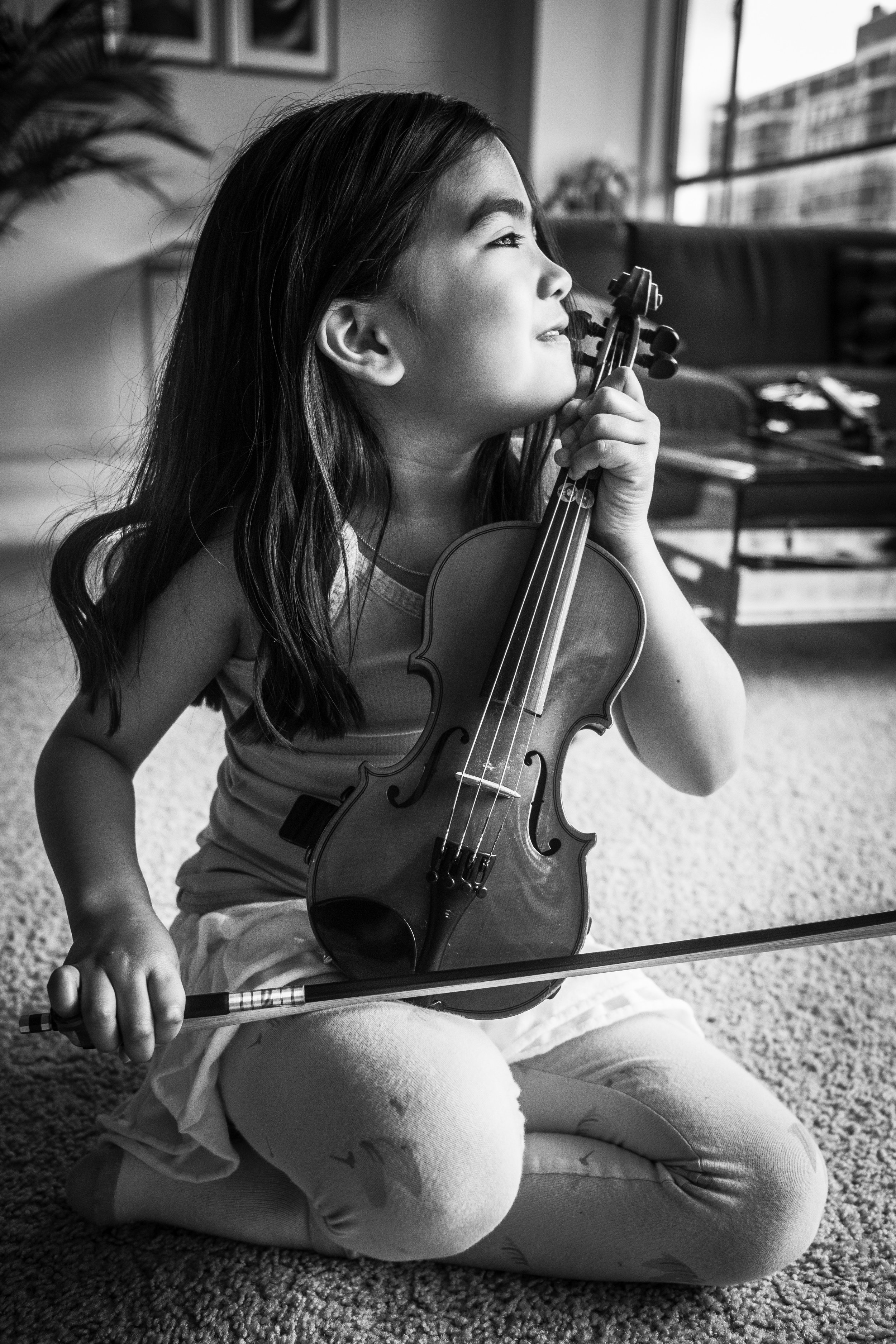 Young violin student enjoying her violin lesson.