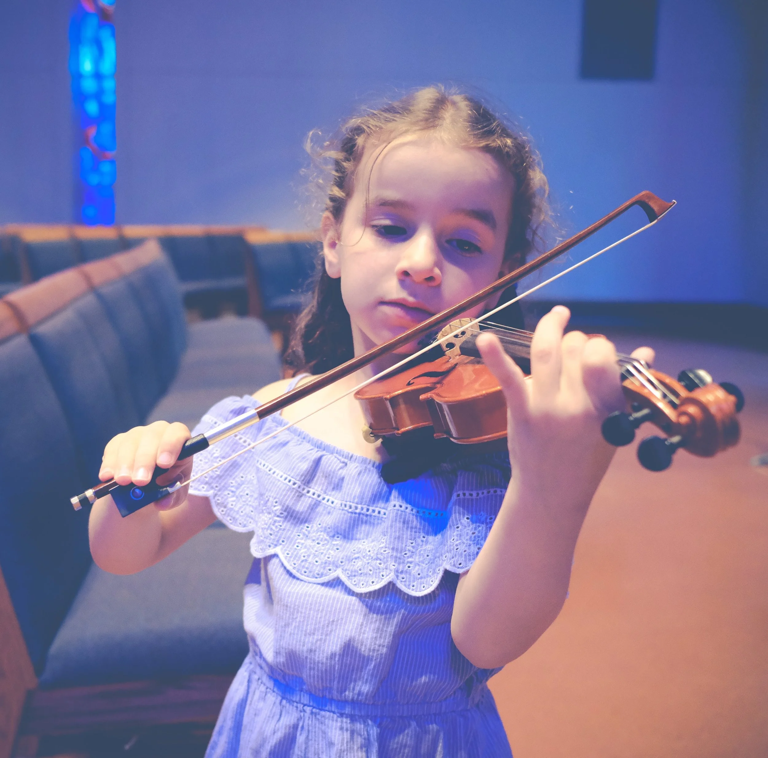 Young violinist performing on stage in concert.