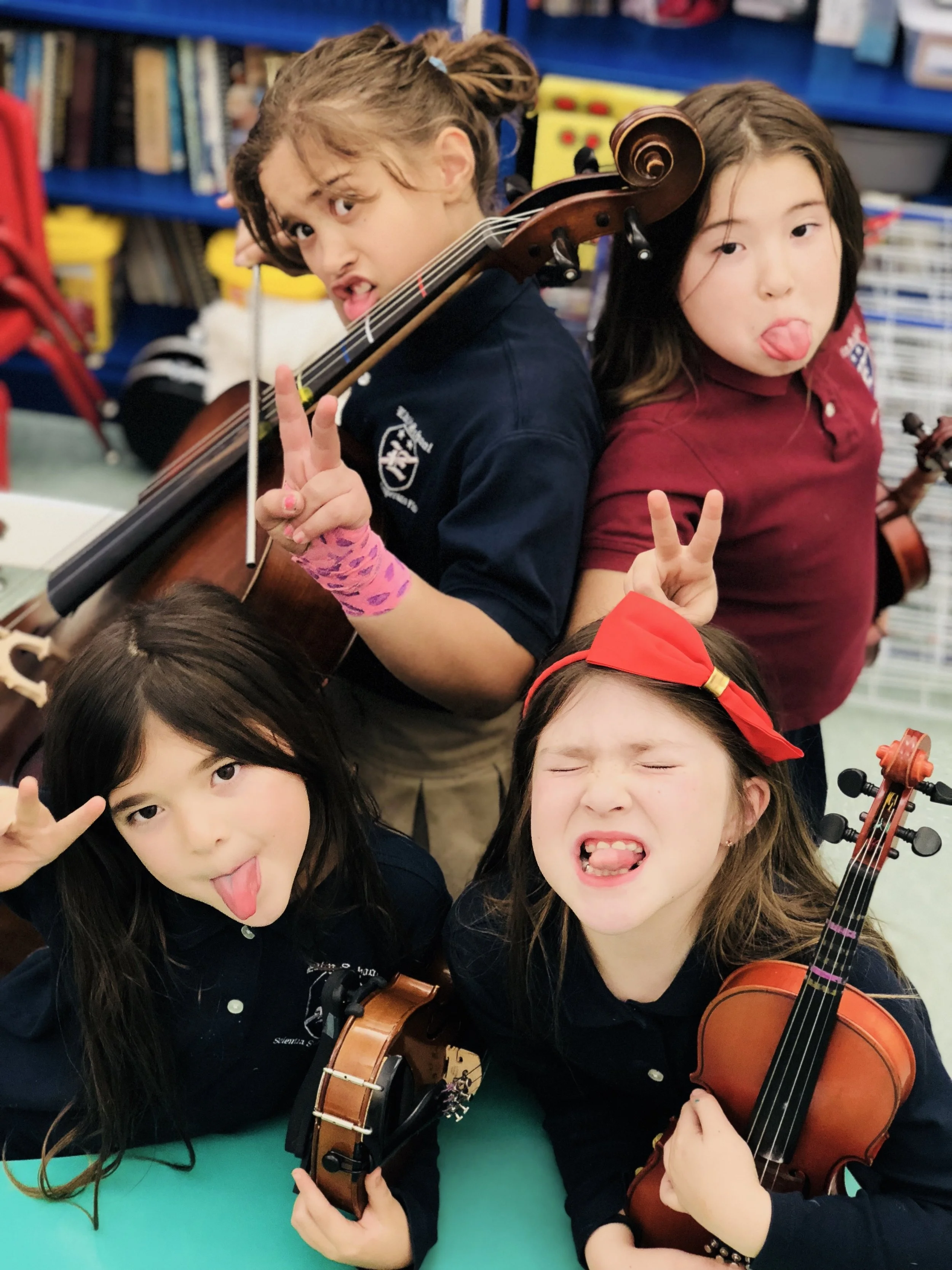 Young music students enjoying a fun moment during a group lesson.