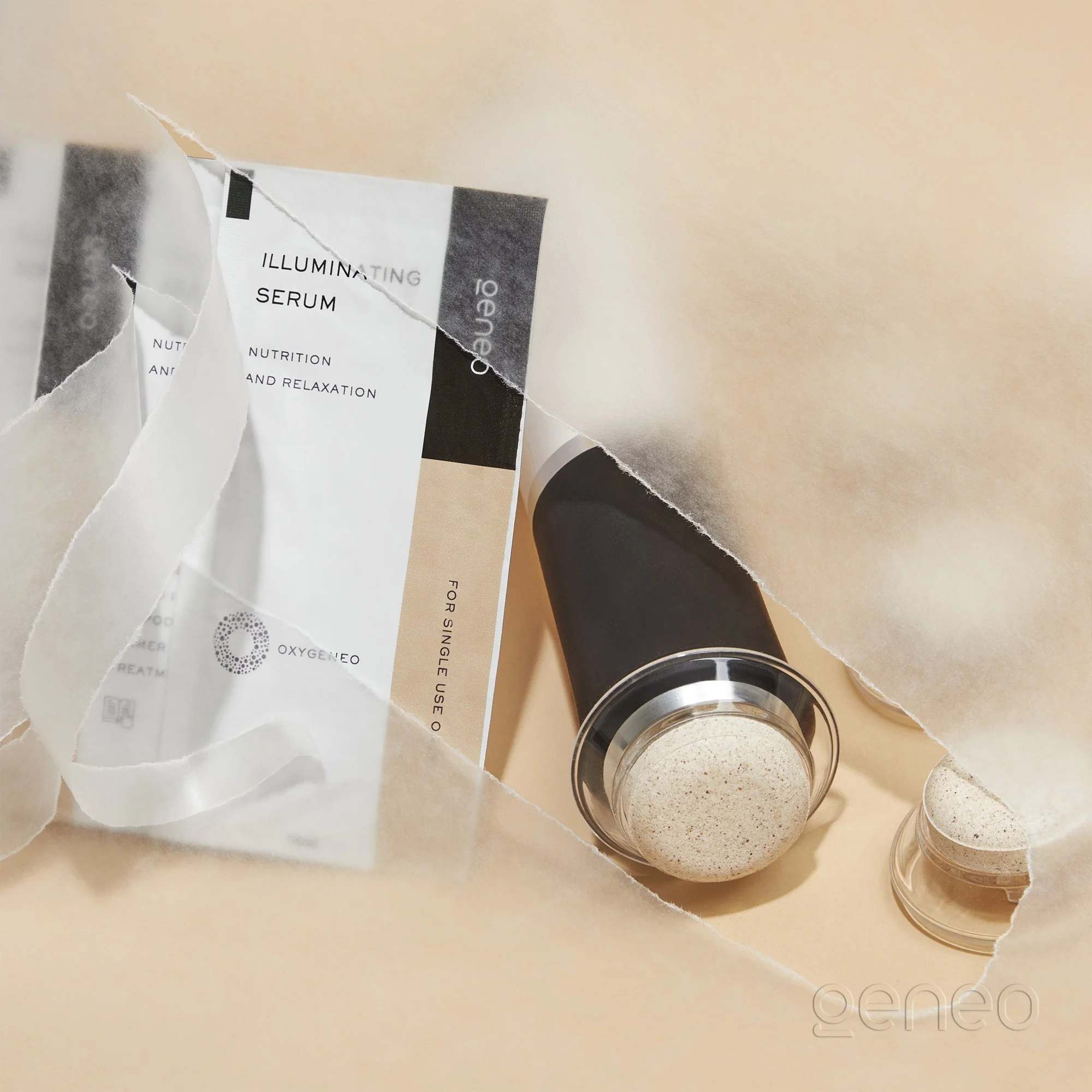 Close-up of torn product packaging for illuminating serum and a small open container with beige powder on a beige surface.