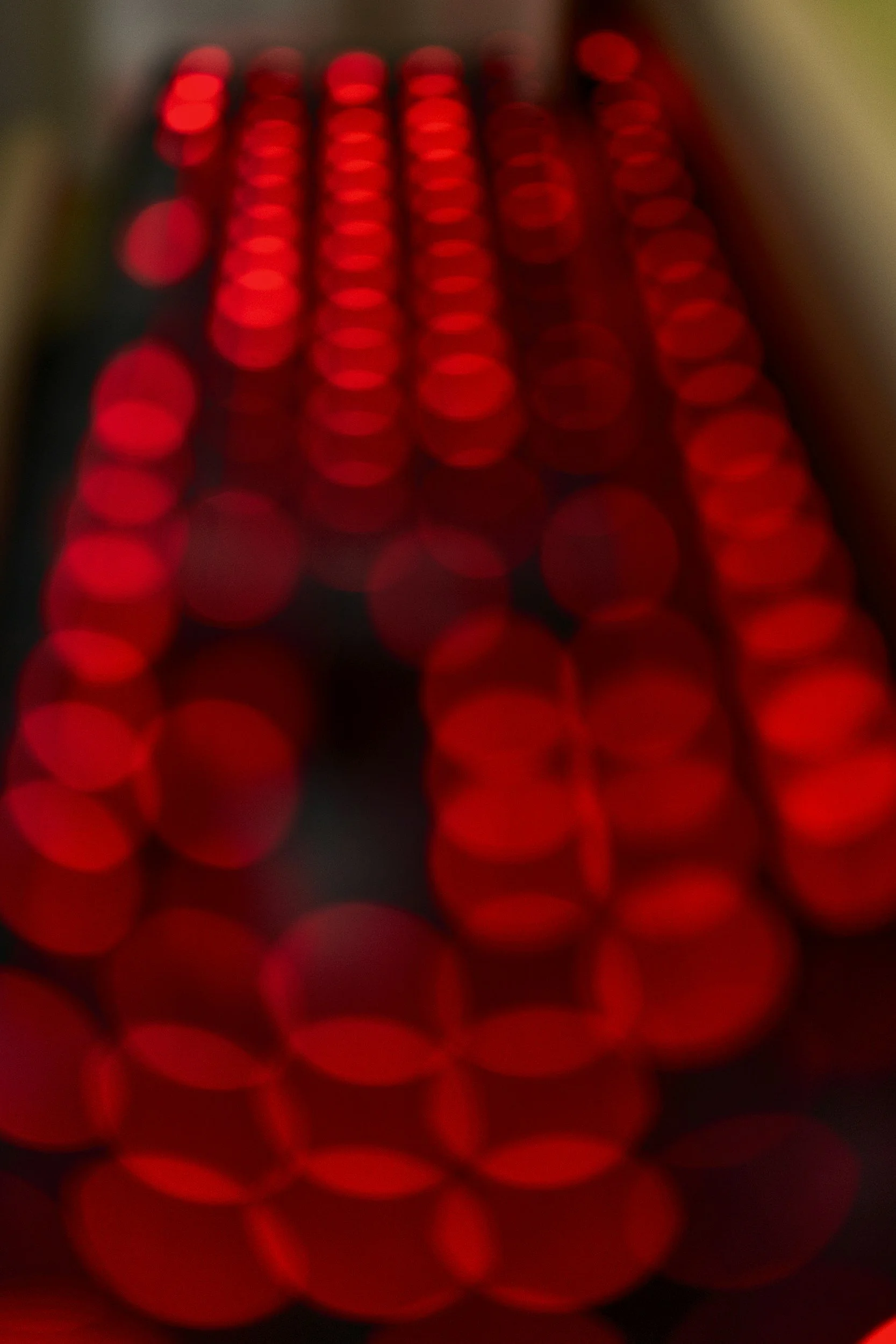 Close-up of red LED lights arranged in a grid pattern, creating a bokeh effect.