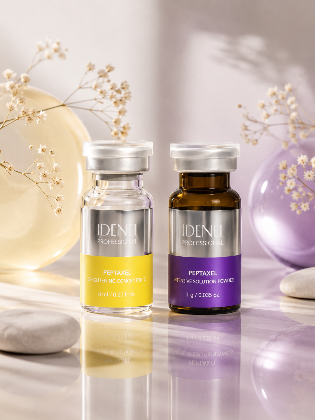 Two bottles labeled 'IDENEL PROFESSIONAL' with skincare products, one yellow labeled 'PEPTAXEL BRIGHTENING CONCENTRATE' and one purple labeled 'PEPTAXEL INTENSIVE SOLUTION POWDER', are placed on a reflective surface with decorative balloons and dried