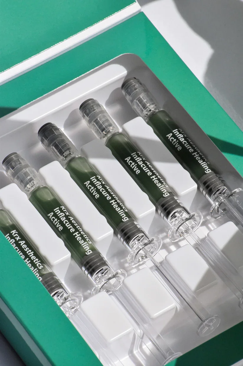 Close-up of Inflacure Healing Infusion ampoules representing an advanced treatment designed to soothe inflammation, strengthen the skin barrier and support skin healing.