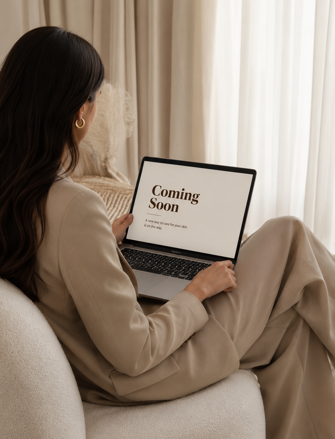 Client using laptop to explore upcoming Skin Symphony Clinic digital skincare tool