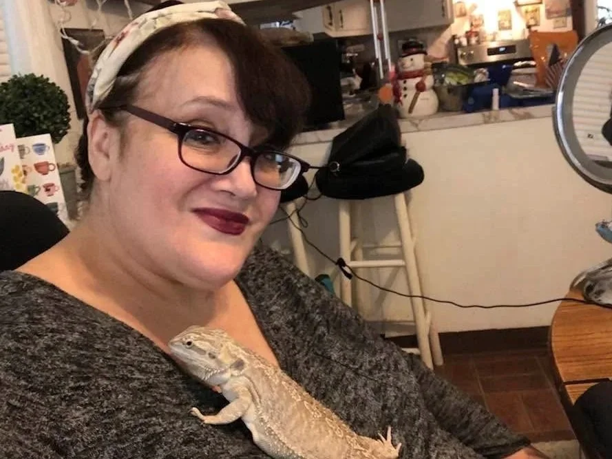 Lady holding a bearded dragon 
