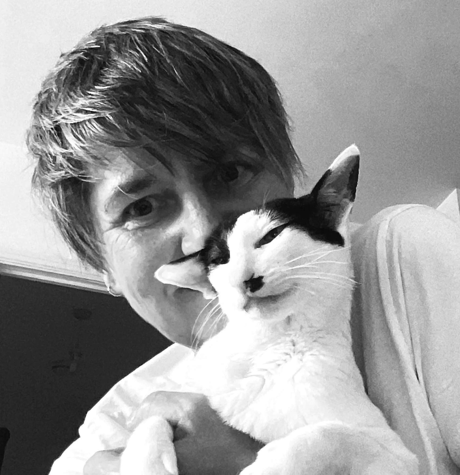 black and white picture of woman and cat cuddling