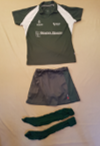 Green polo shirt, navy shorts, and dark socks laid out on a surface.