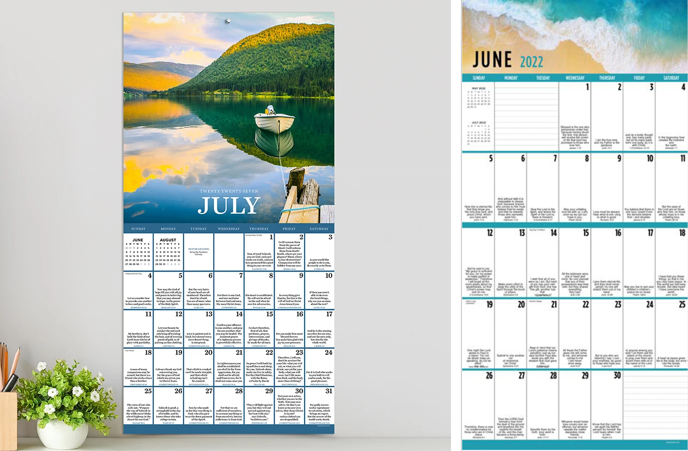 Calendar for July and June 2022, with a scenic cover photo of a lake, boat, mountains, and trees, hanging on a wall.