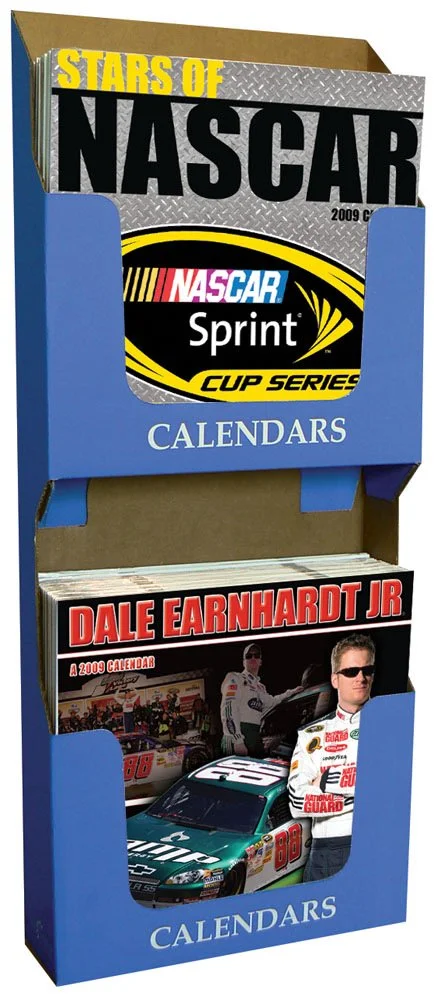 A blue display stand holding calendars, including one titled 'Stars of NASCAR 2009 Calendar' and another titled 'Dale Earnhardt Jr. 2009 Calendar' featuring images of Dale Earnhardt Jr.