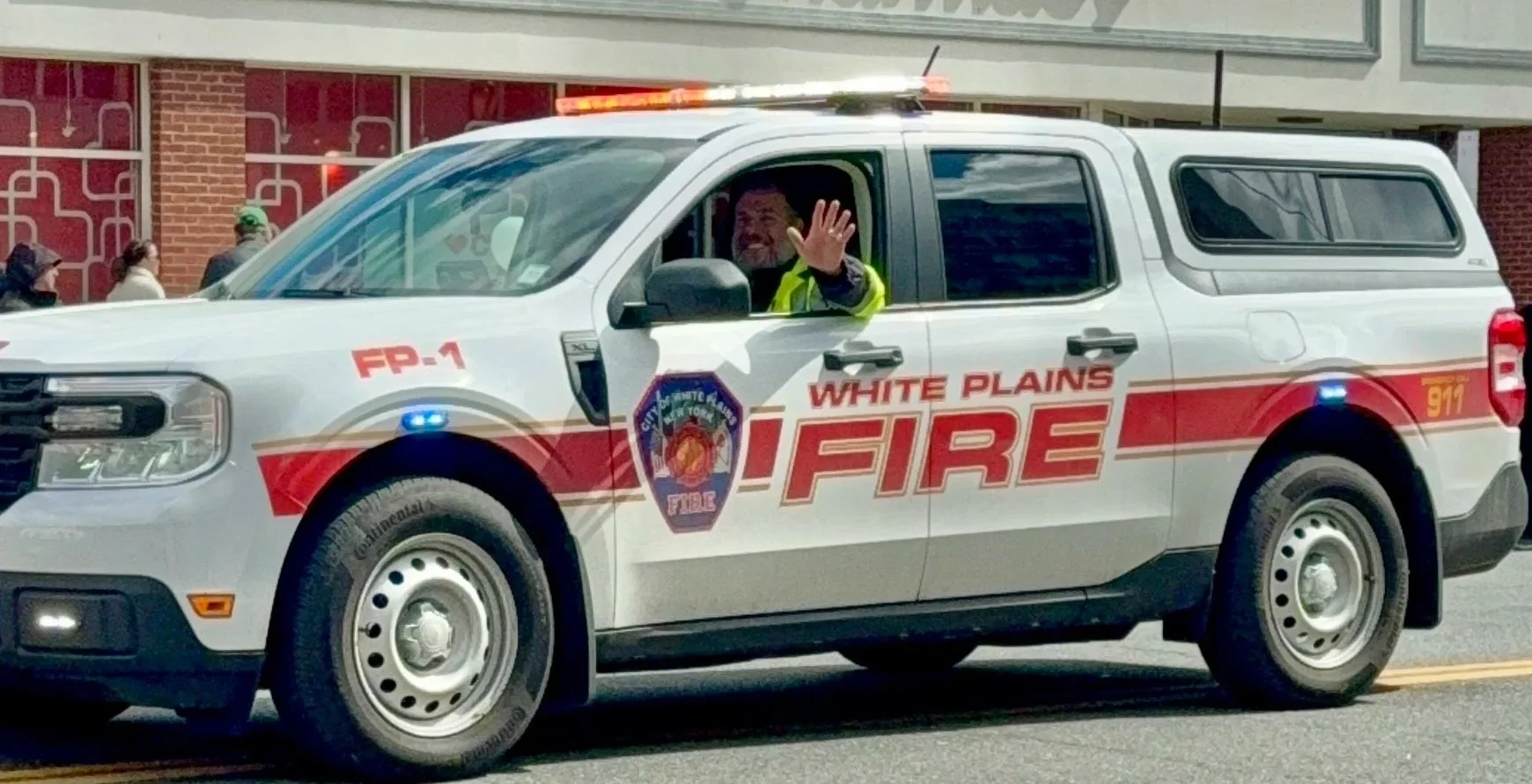 Photo of White Plains Common Council candidate John Cambareri driving a White Plains Fire vehicle.