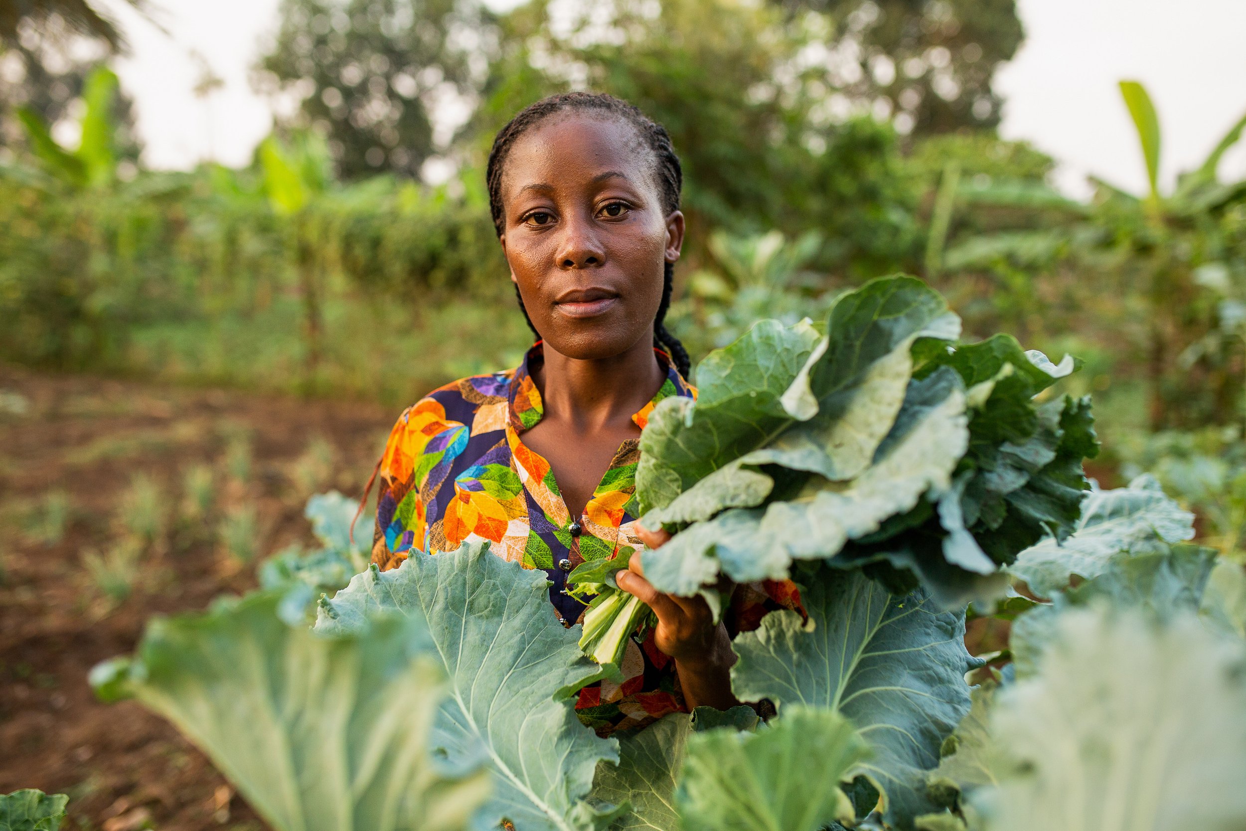 Ruth holds her kale crop in her hands.