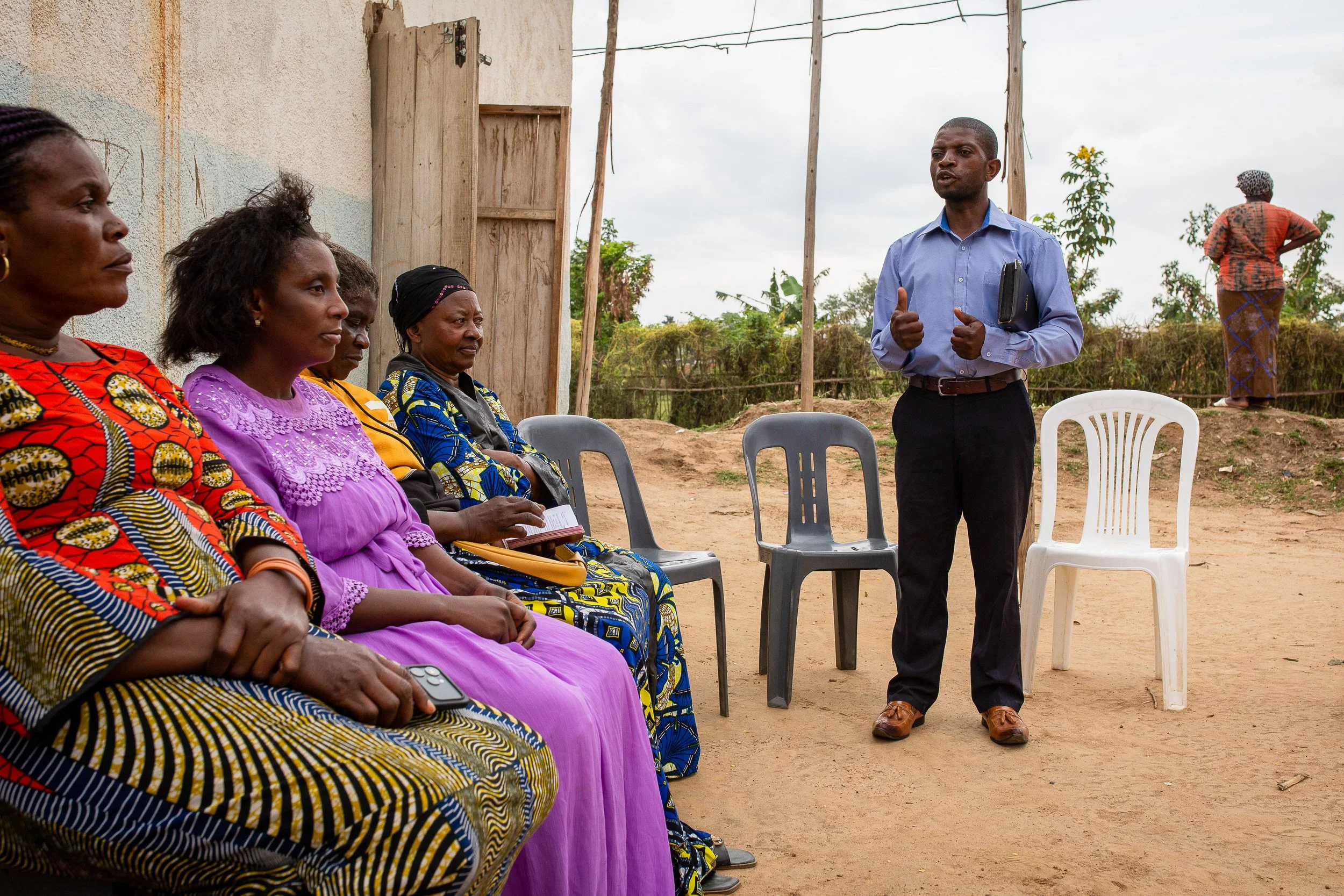 Joshua meets with his church members during an evening gathering. 