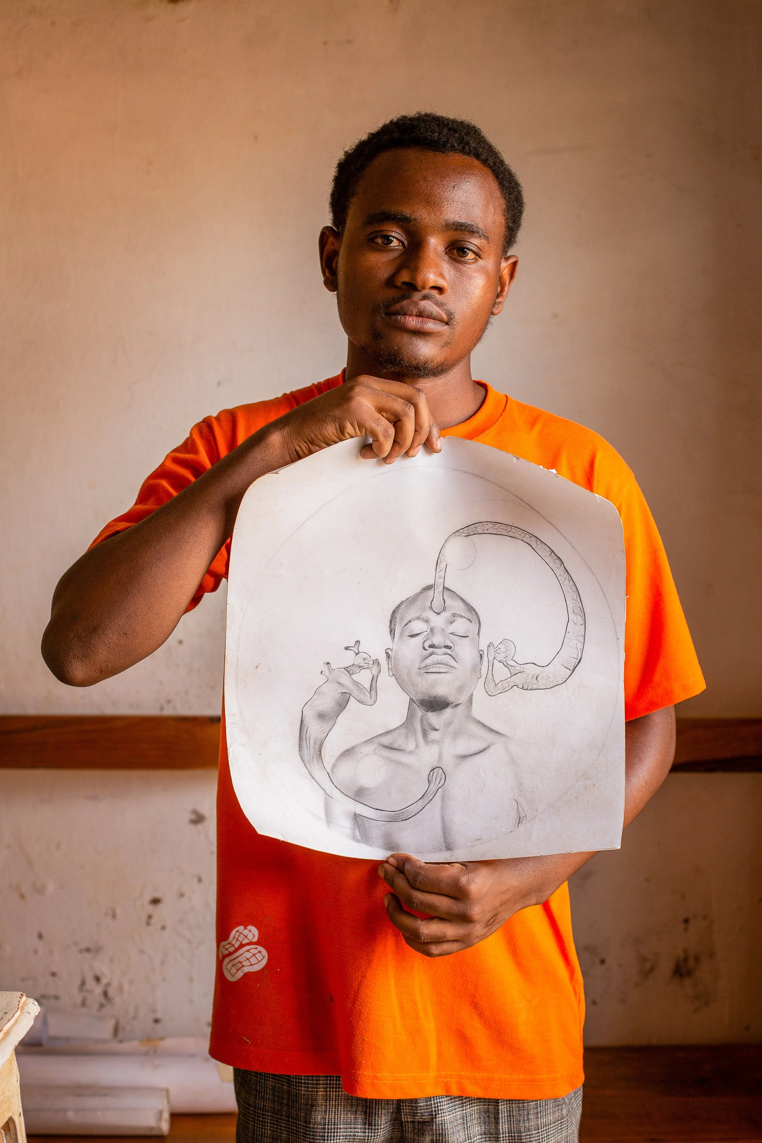 Savino shows off one of his drawings, which he says represents the hole between between the heart and knowledge  while making decisions.