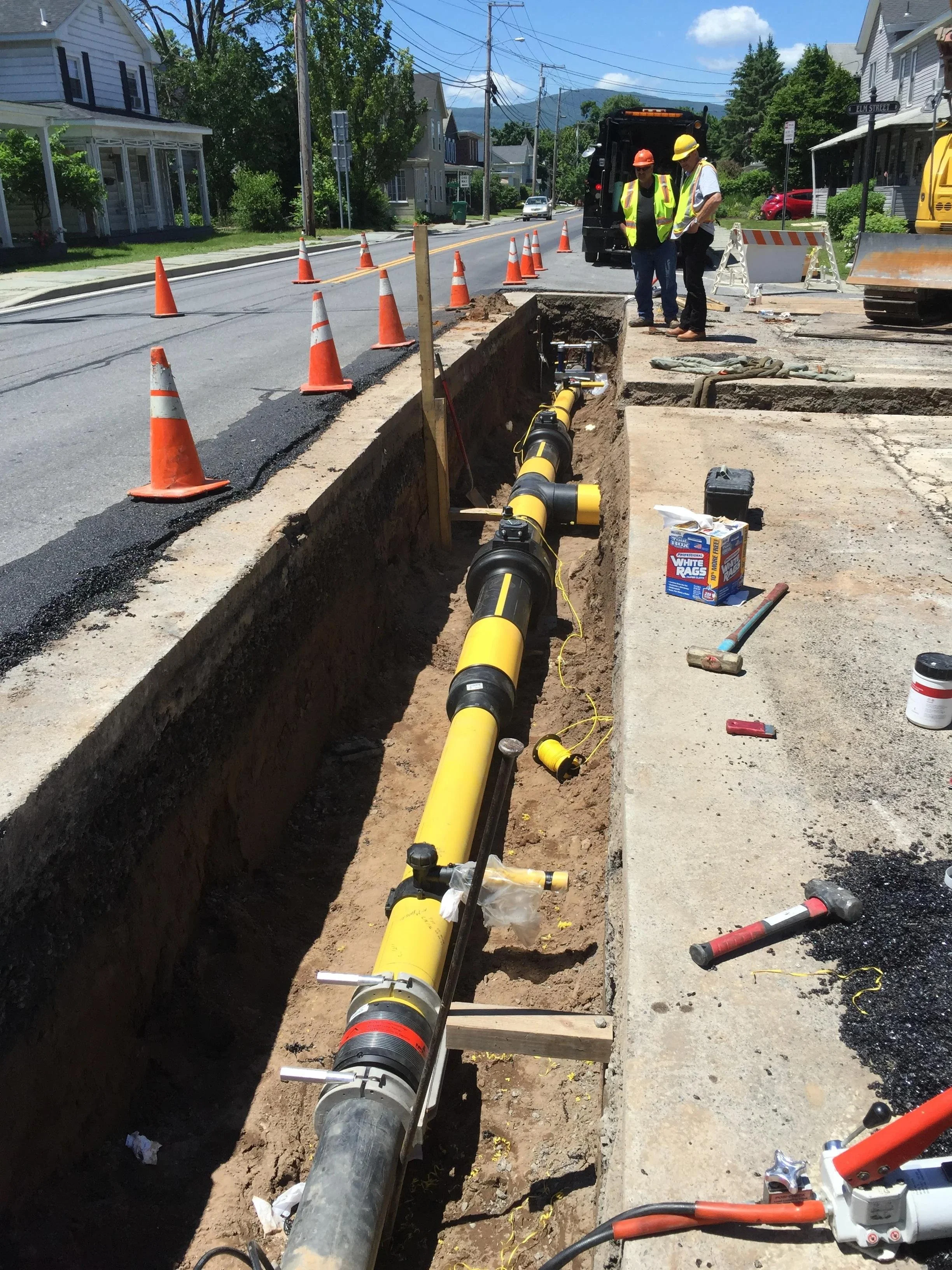 Underground utility installation by the Hudson Company crew in a residential area.