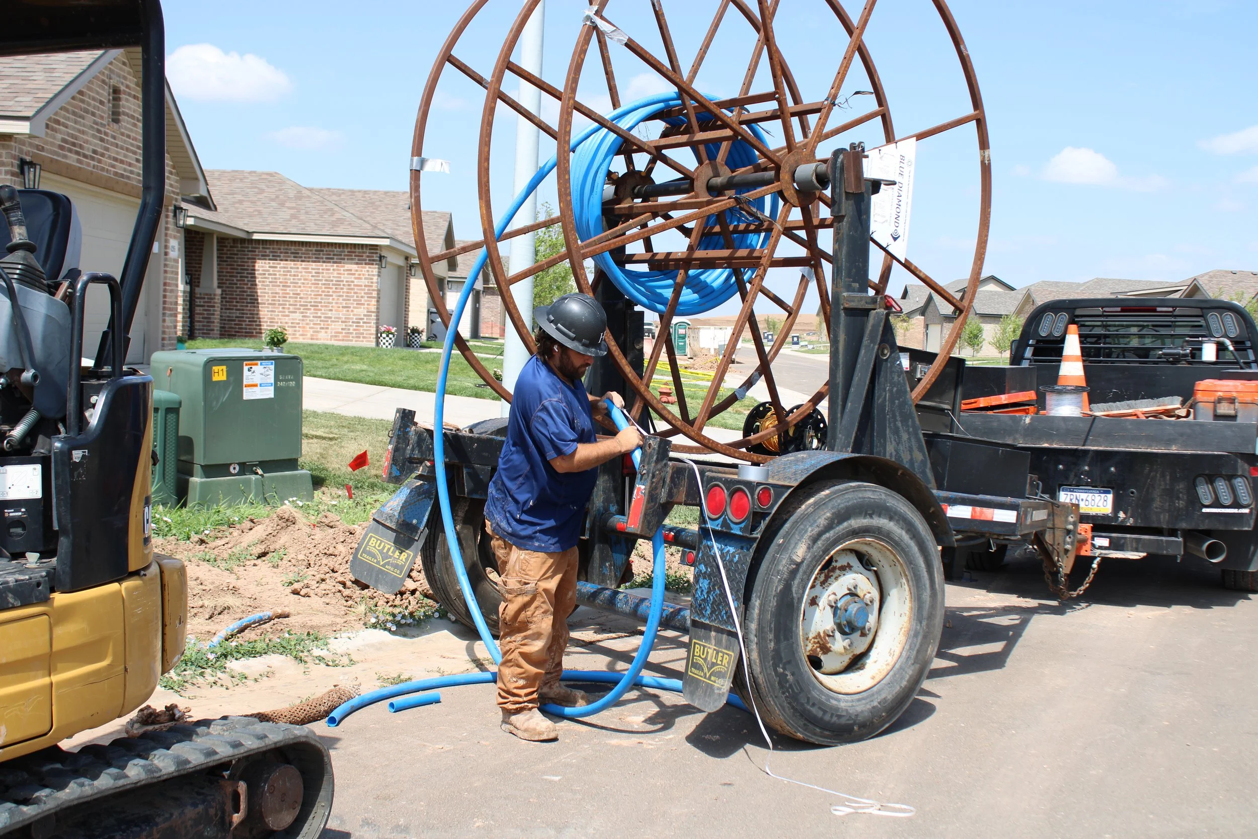 Hudson Company crew operating utility equipment at a residential job site.