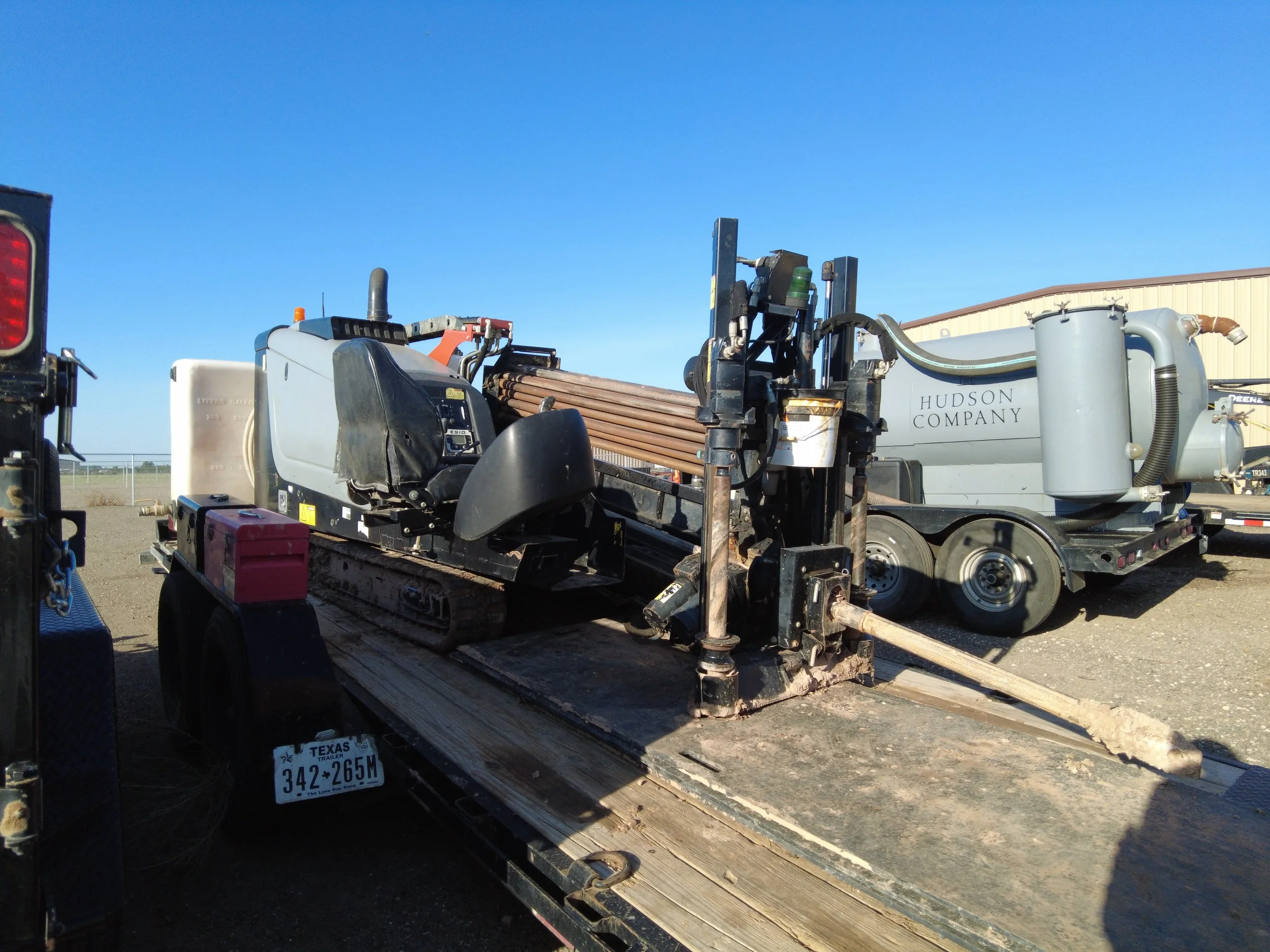 Hudson Company hydro excavation equipment and trailer at the company yard.