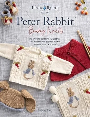 Cover of a knitting book titled 'Peter Rabbit Baby Knits' showing two baby sweaters with Peter Rabbit designs, a pair of baby shoes, and some knitted items and accessories on a textured surface.