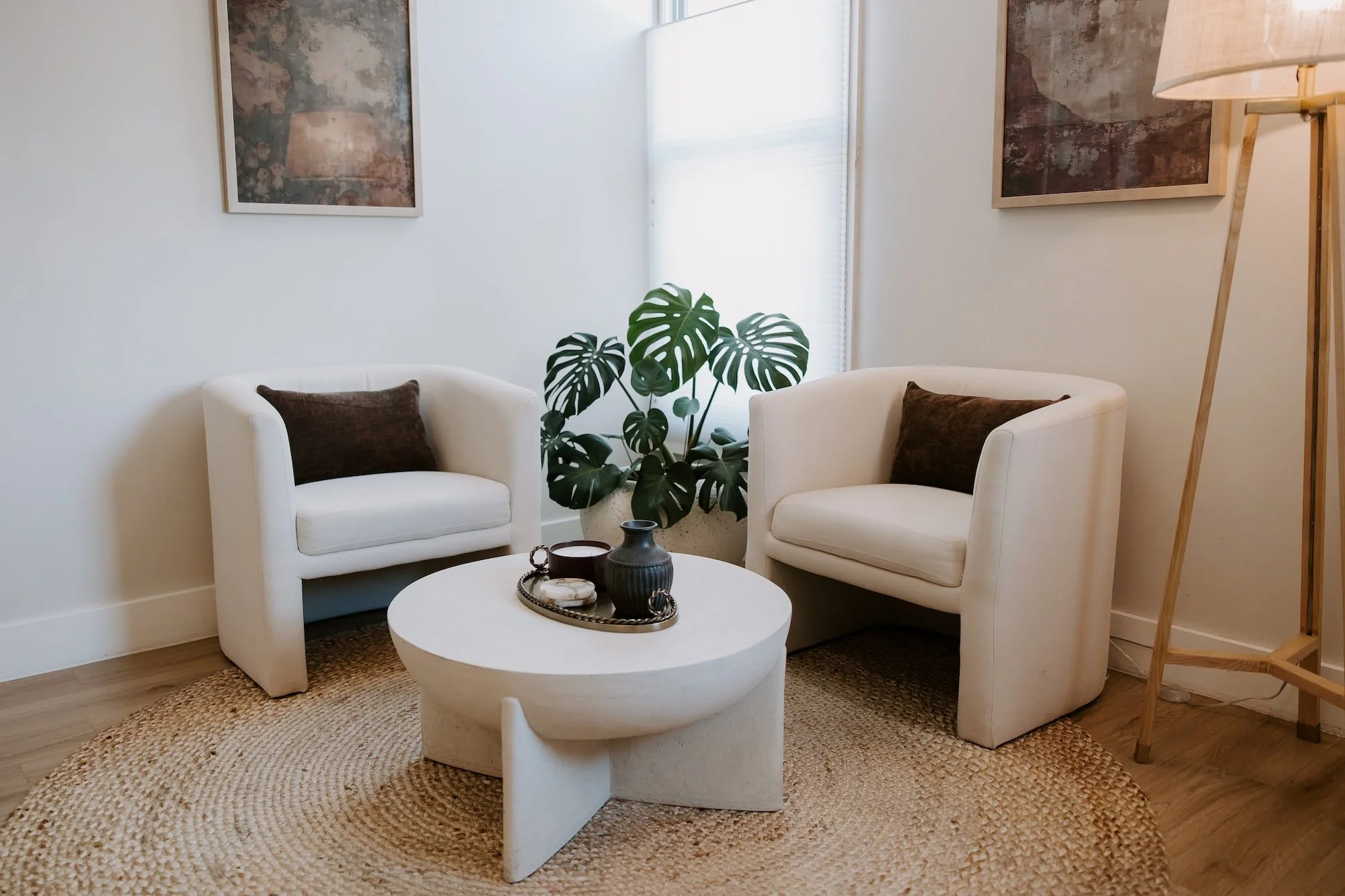 Welcoming trauma therapy office in Denver with two cream chairs and a plant