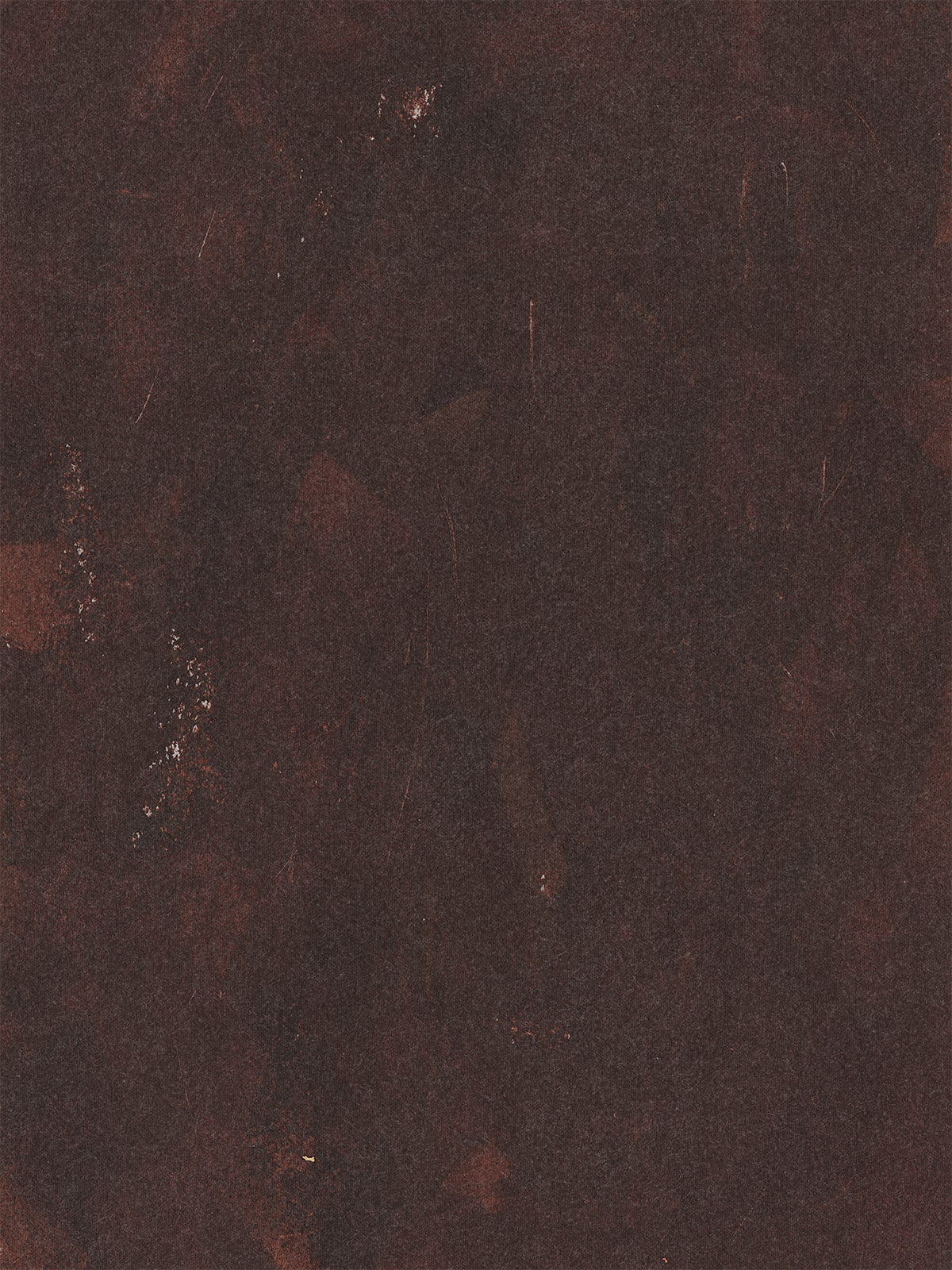 Dark, textured surface with reddish-brown tones and subtle scratches and marks.