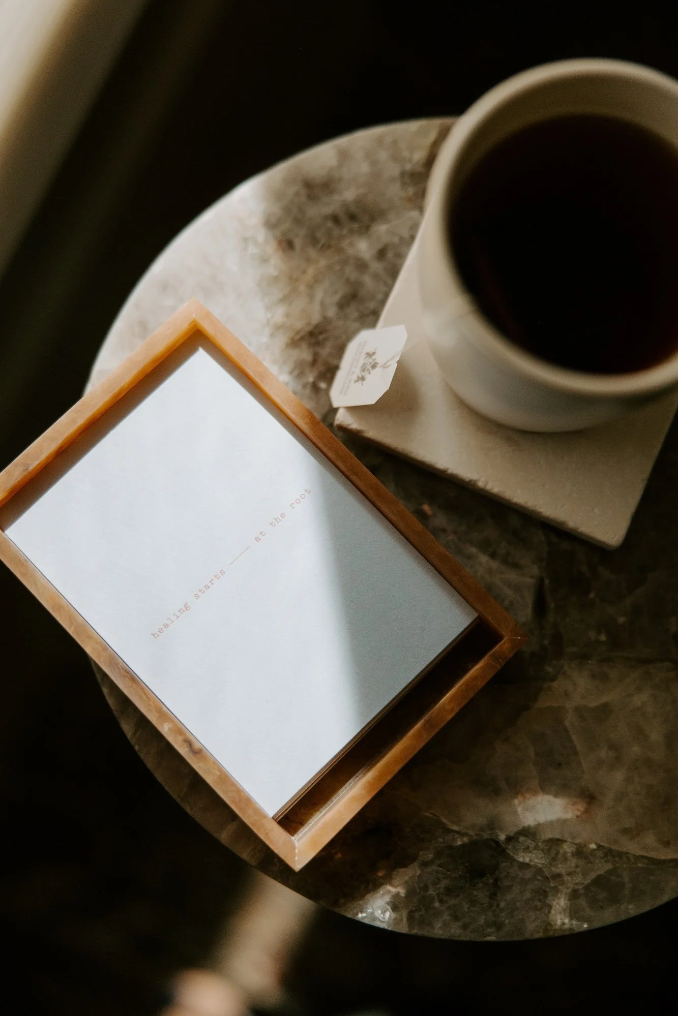 Mug beside a branded card that reads “Healing starts at the root.”