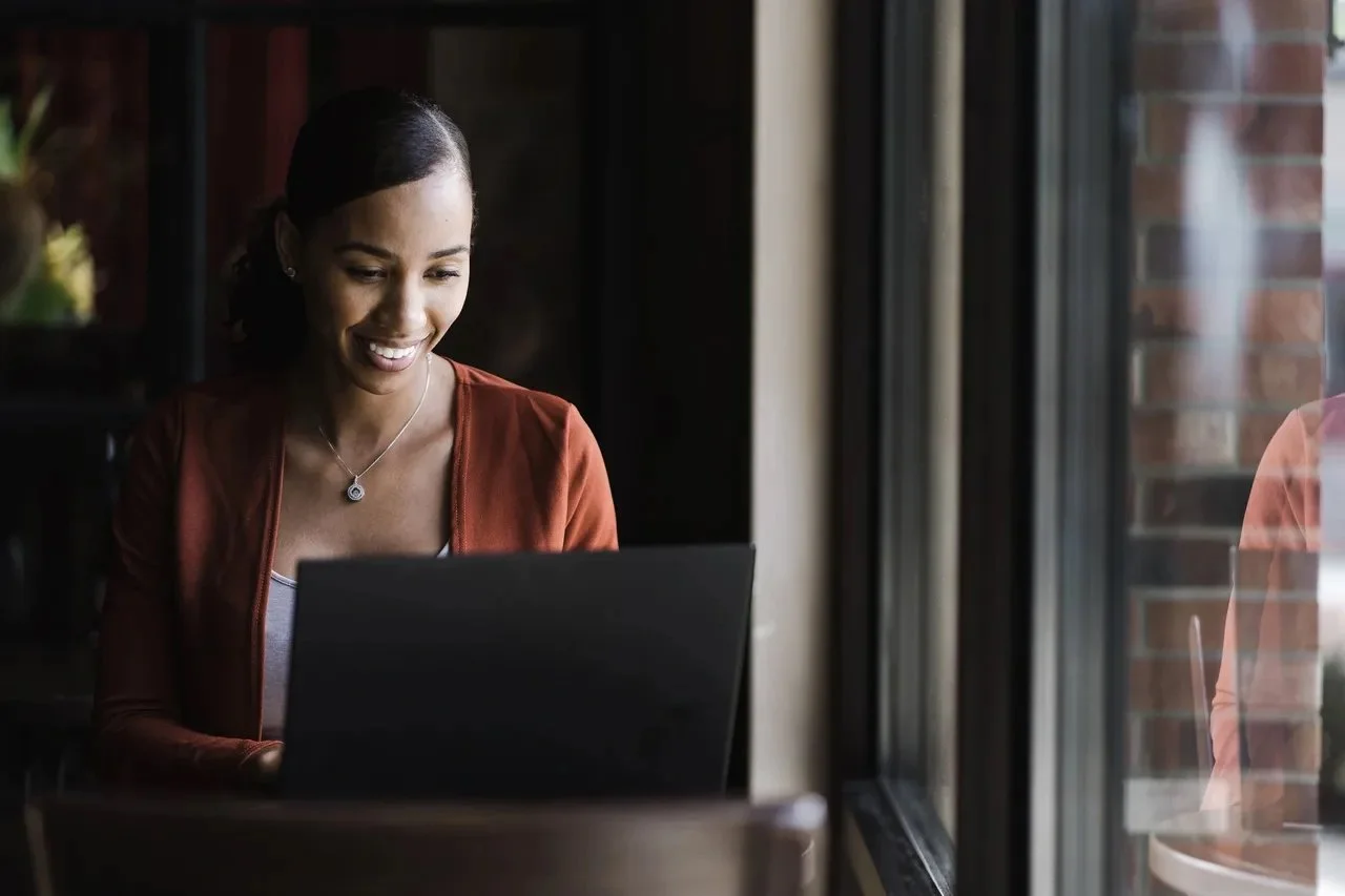 Black woman working on computer in office