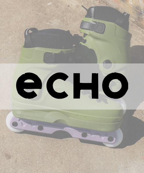 A green and black ECHO freeskate with a large "ECHO" logo on it, placed on a concrete surface.
