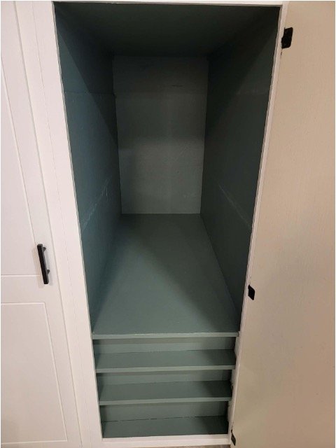 Empty pantry cupboard interior before drawer installation