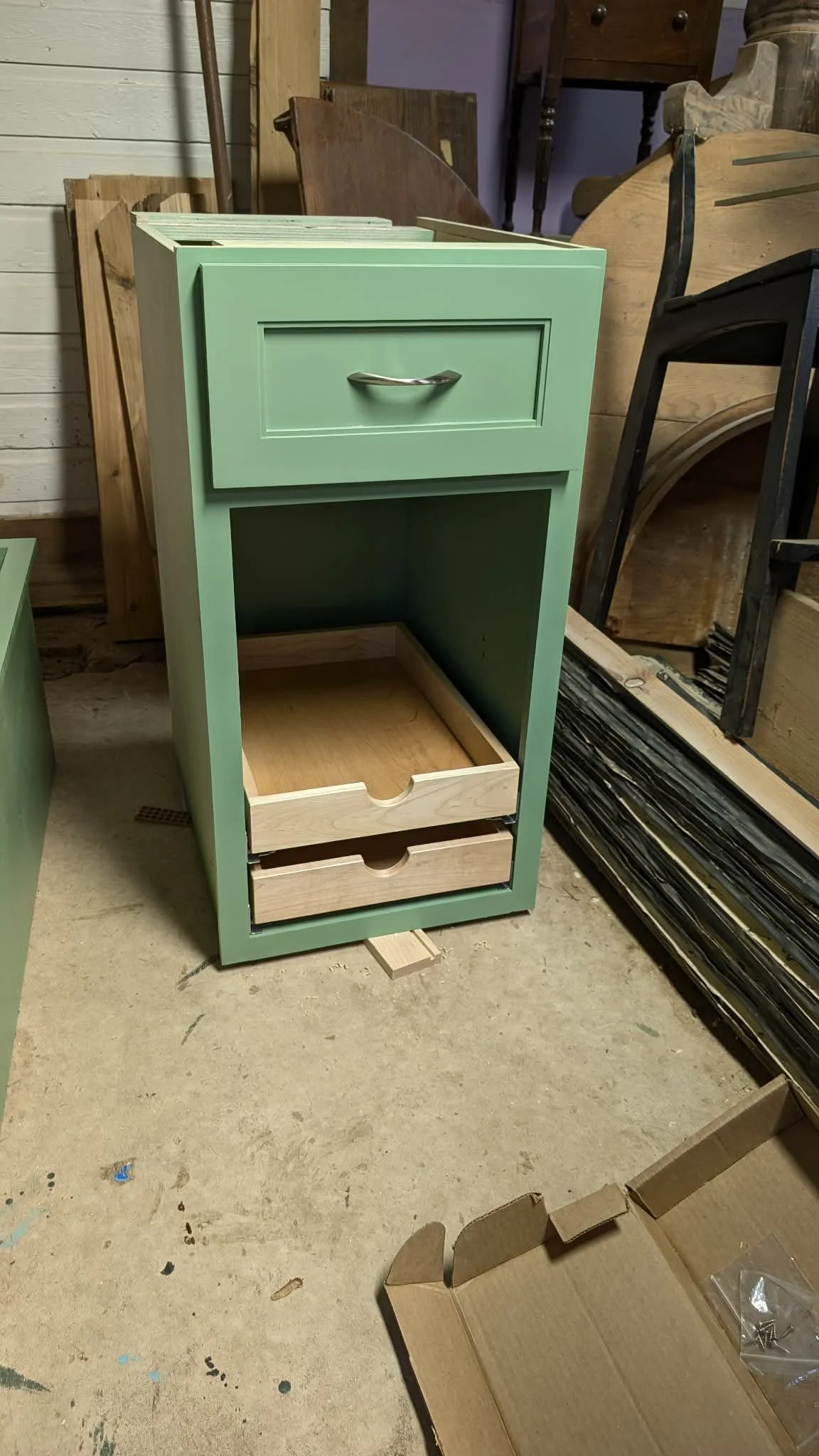 Painted green cabinet with pull-out drawers