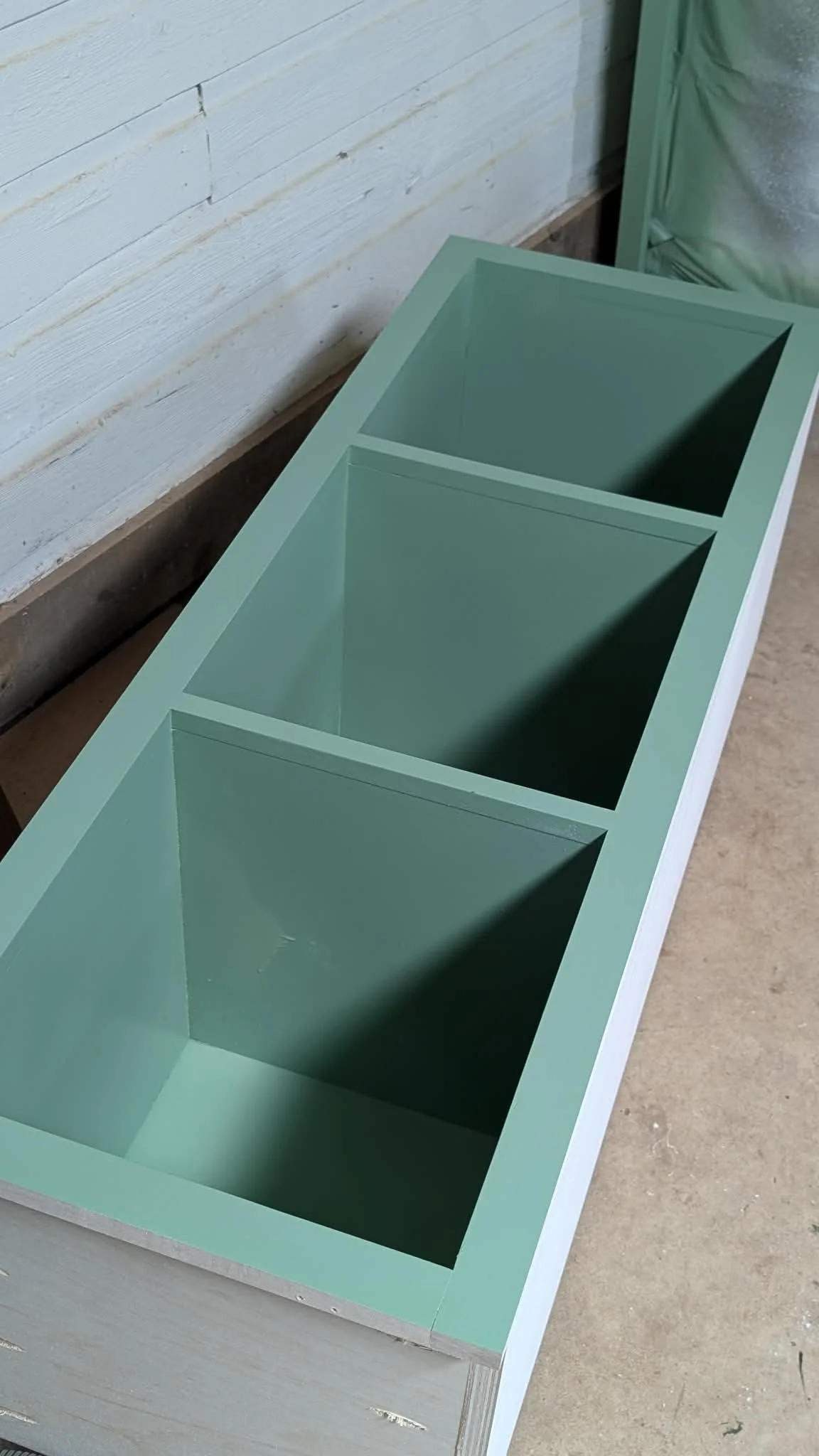 Interior cubby dividers in painted green cabinet