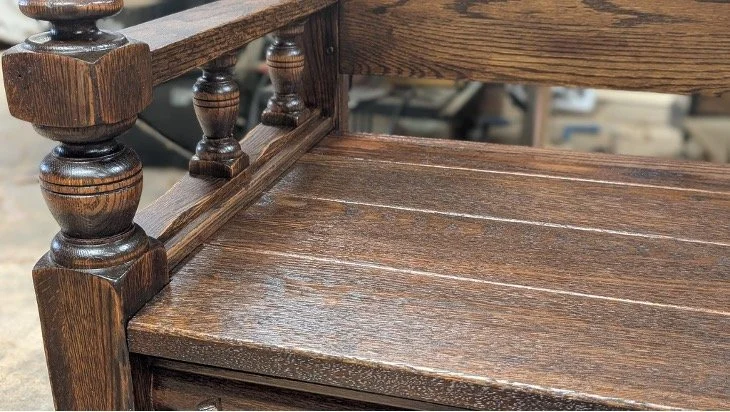 Close-up of the custom oak bench seat and finished wood grain.