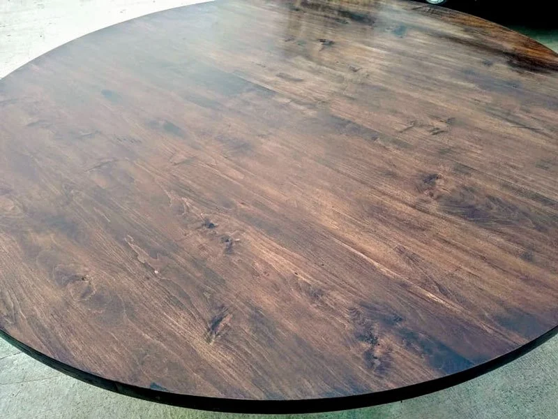 Closeup of round wood tabletop grain and finish