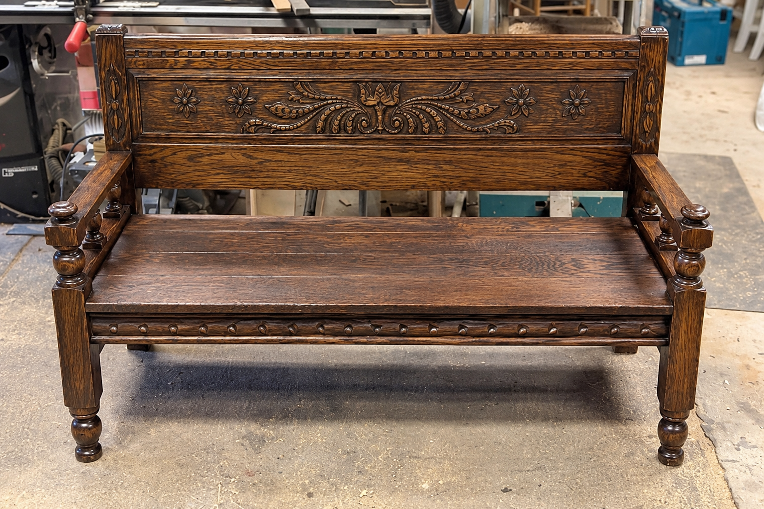 Completed antique bed-to-bench conversion with carved wood components, custom seat, and matching apron.