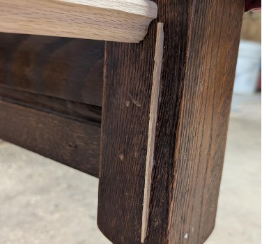 Original bed-hook slot filled with a fitted strip of oak during the bench conversion.