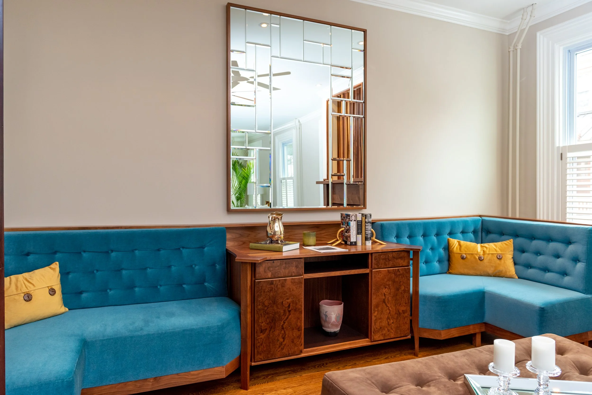 Walnut Cabinetry, mirror above, with turquoise couches