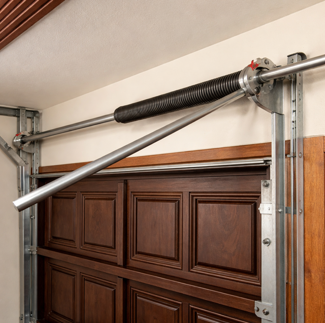 extension torsion spring coils next to steel track
