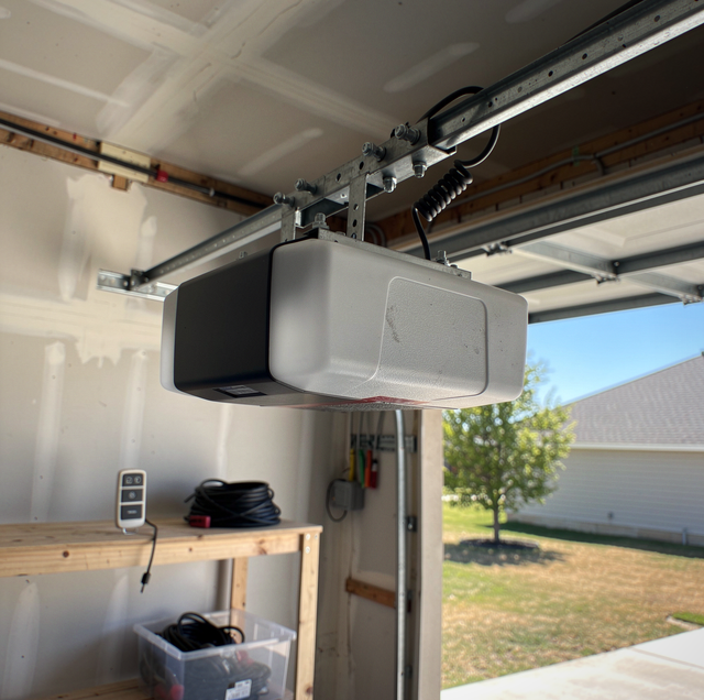 single white garage door remote on cracked concrete floor