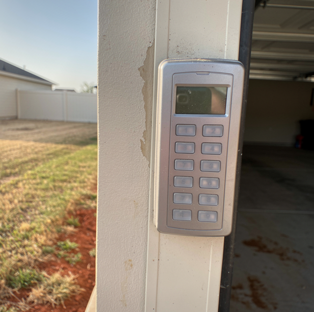 wireless garage door keypad mounted on sunlit door jamb
