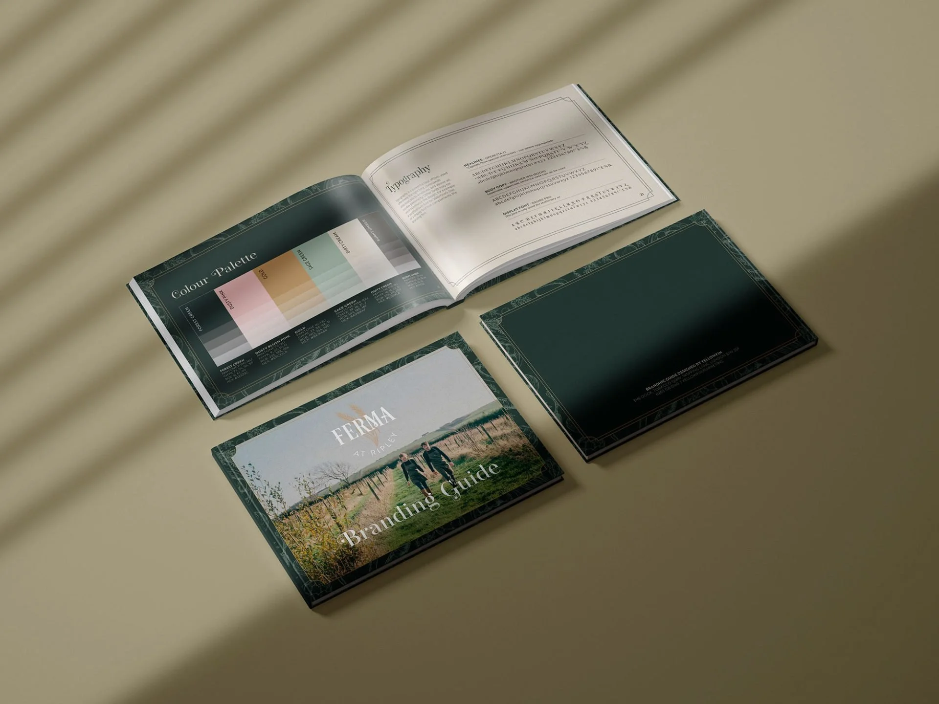 Open books displaying branding guides, color palette, typography, and a guide with scenic outdoor images, placed on a beige table.