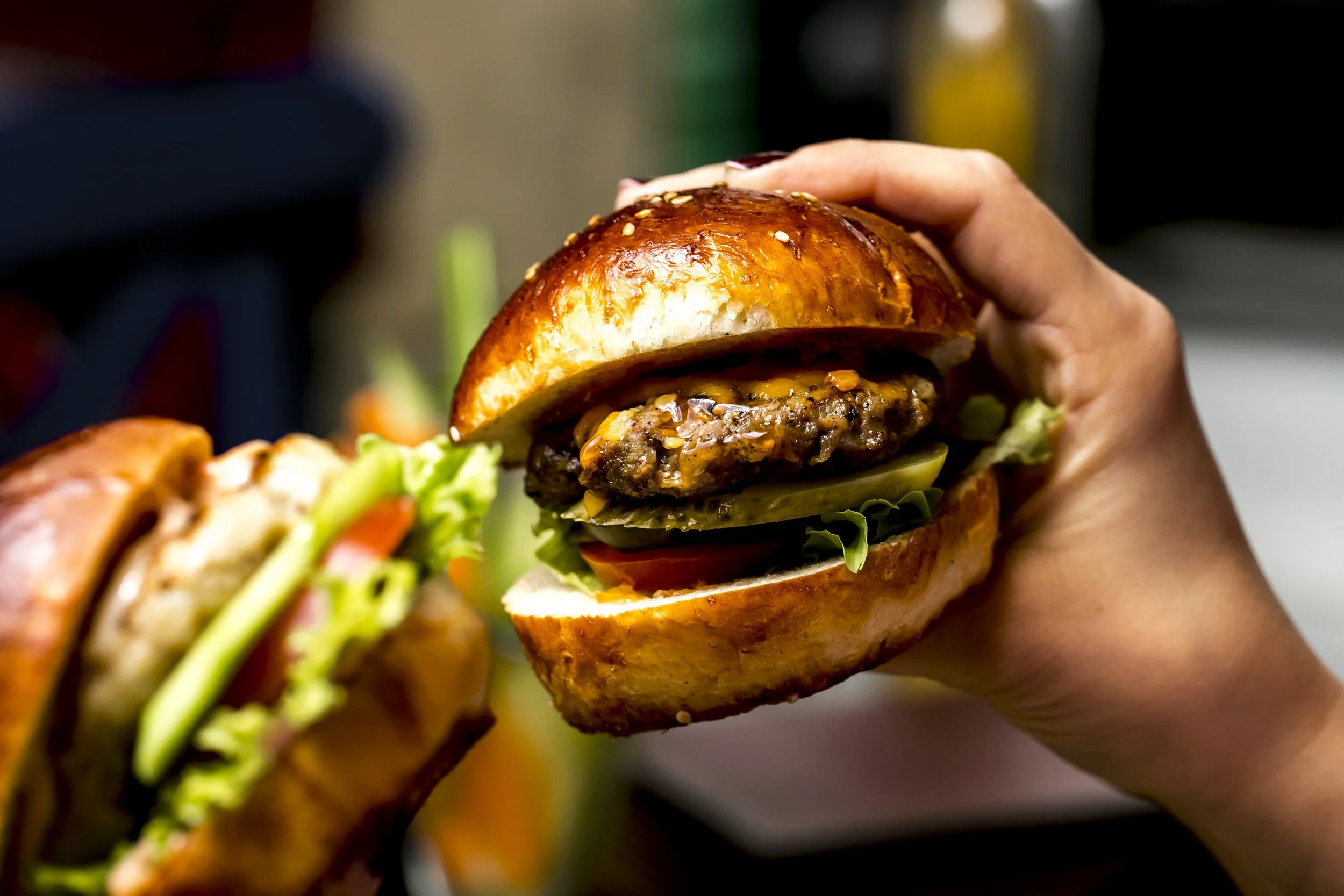 man-holds-meat-burger-side-view.jpg