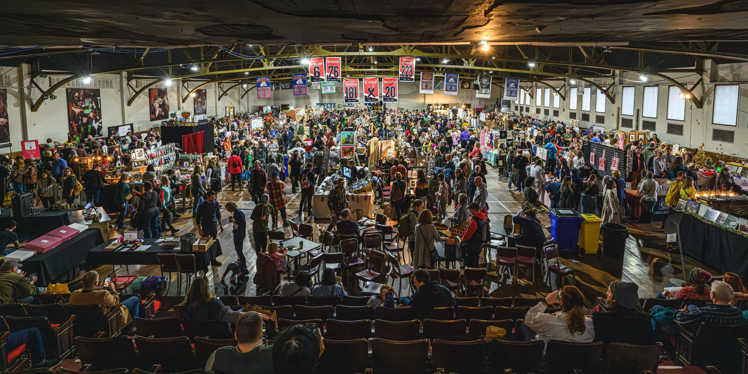A packed shot of the Detroit Urban Craft Fair (DUCF) from the air in the stands, showing a massive crowd of happy shoppers browsing a unique selection of some of Michigan's best makers and crafters!