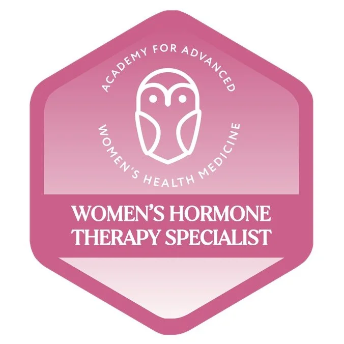 Pink badge with outline of an owl at the top, text around it reading 'Academy for Advanced Women's Health Medicine', and bold text below stating 'Women's Hormone Therapy Specialist'.