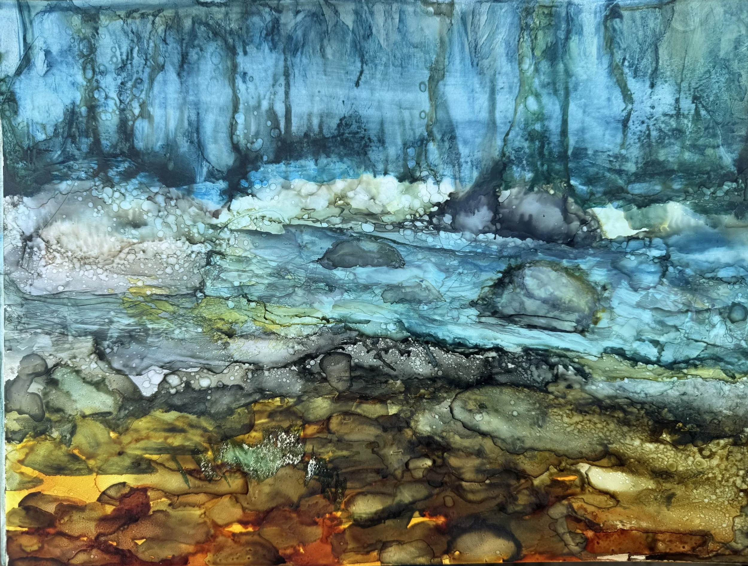 Abstract watercolor painting with shades of blue, black, yellow, and orange blending and dripping downward.