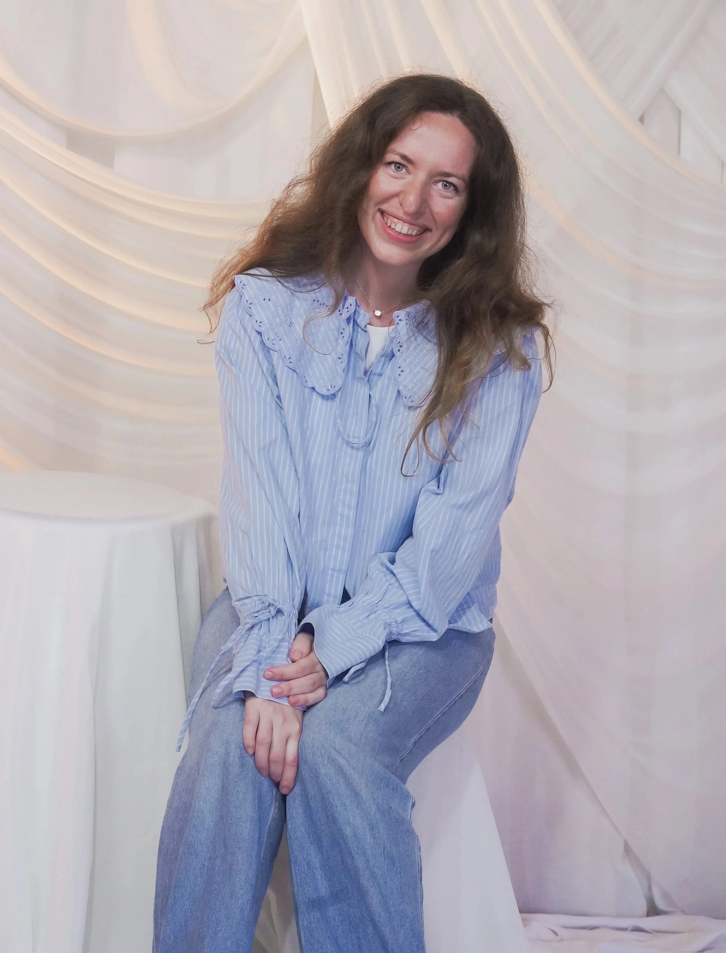 Joy Carignan seated and smiling.