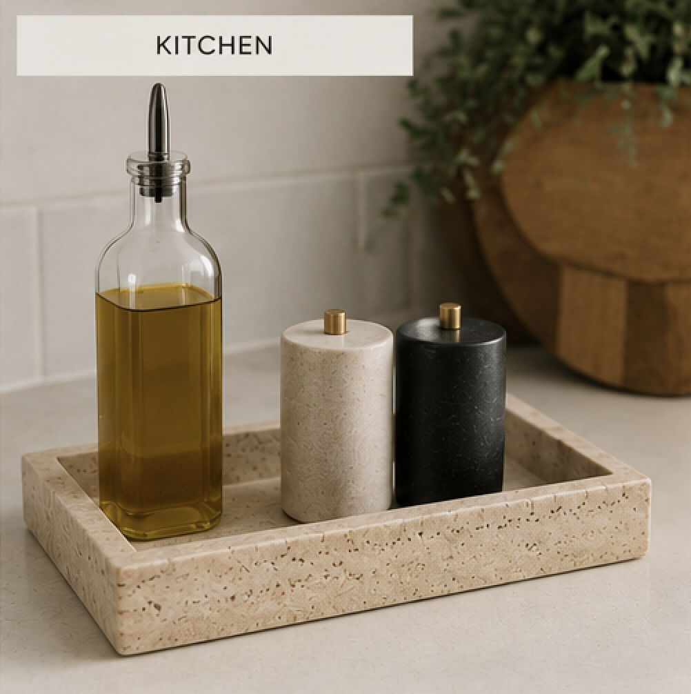 Travertine kitchen tray styled with olive oil, salt and pepper shakers, and a small potted herb on a clean kitchen countertop.