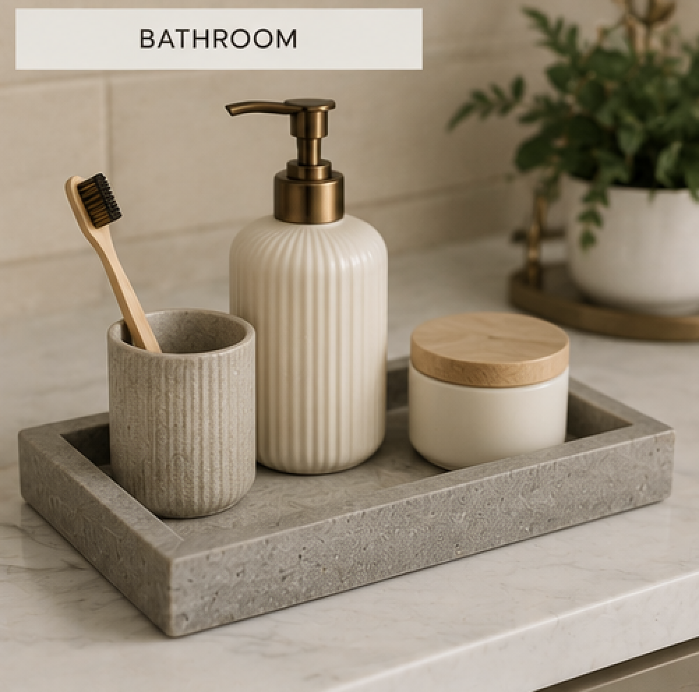 Concrete decorative tray on a bathroom vanity holding a soap dispenser, toothbrush holder, and candle for a clean, spa-inspired look.