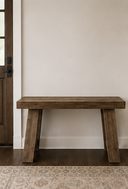 Warm wood console table styled in a bright neutral entryway before adding decorative accessories
