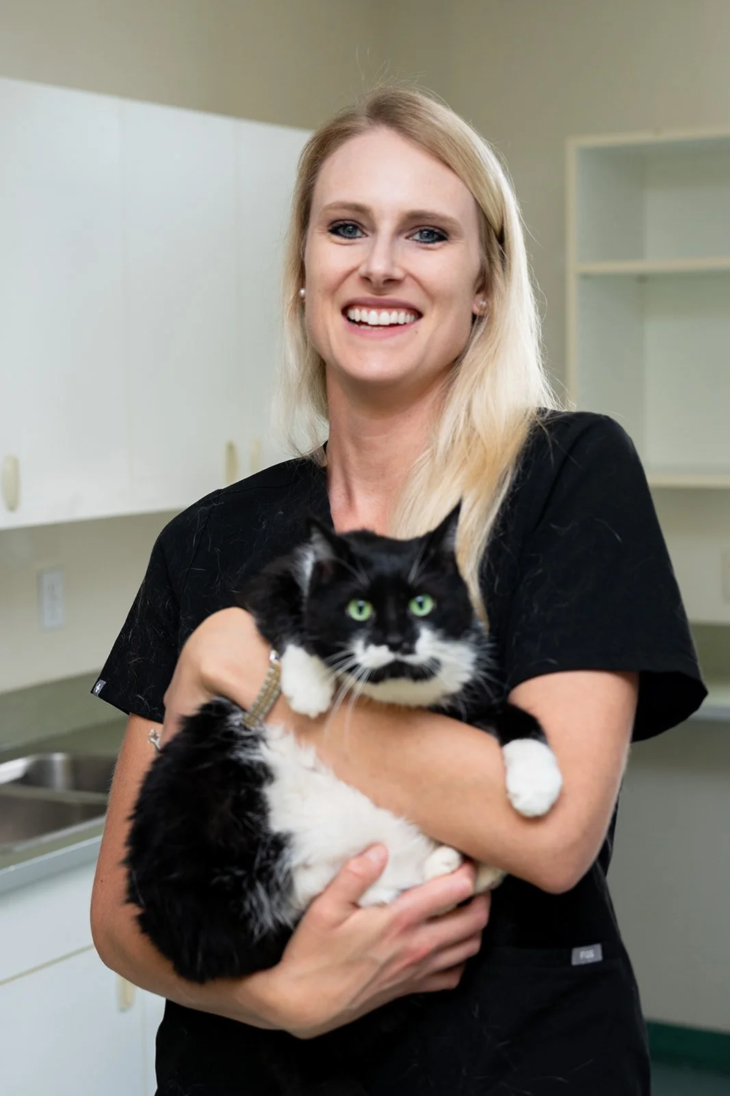 Dr. Katy Weber, emergency vet care in Saskatoon Canada, headshot with her black and white cat
