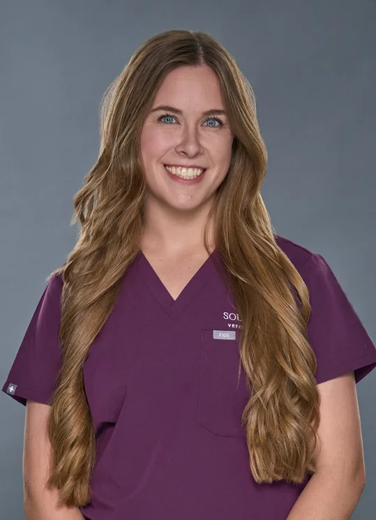 Jesse headshot, woman with long hair and in purple scrubs