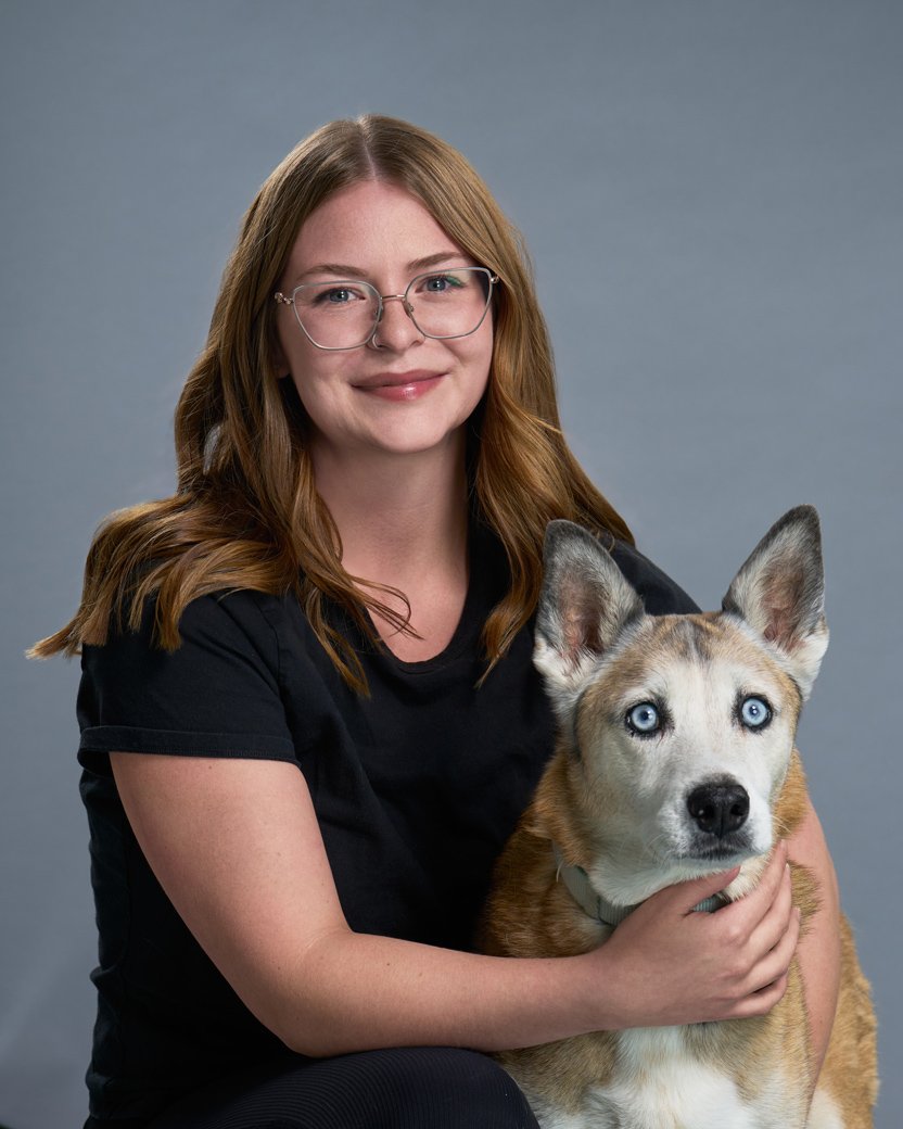 McKenzie Headshot, young woman in glasses with her dog
